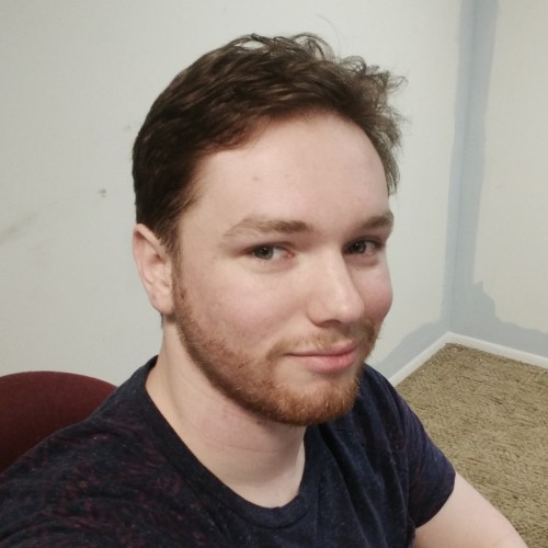 photo of me: a strapping young fellow with short brown hair and a trimmed red beard. More of the right side of my face is visible, and I have a calm expression, and neither smiling nor frowning.